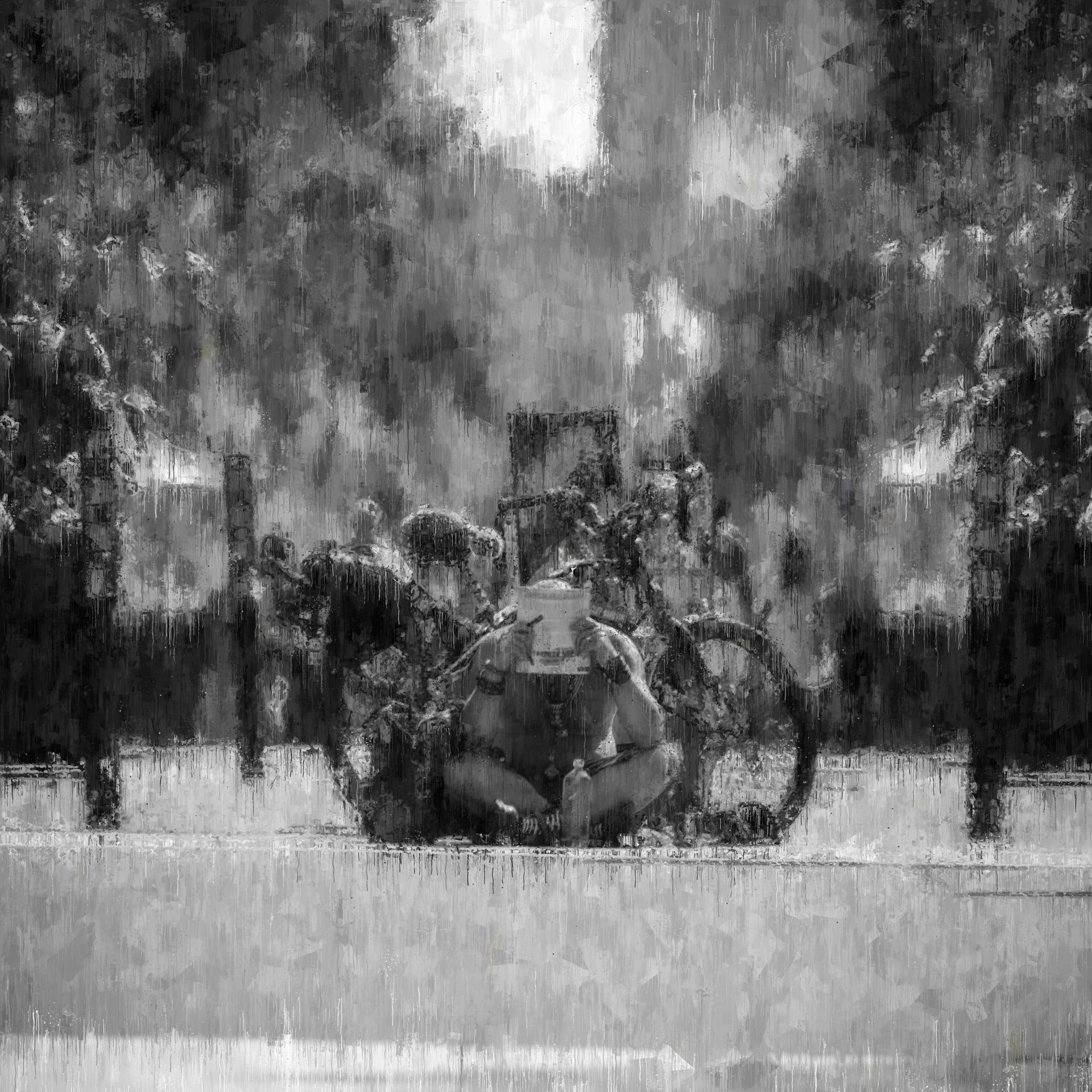 Black and white impression of a person sitting with a bicycle, reading, in a park.