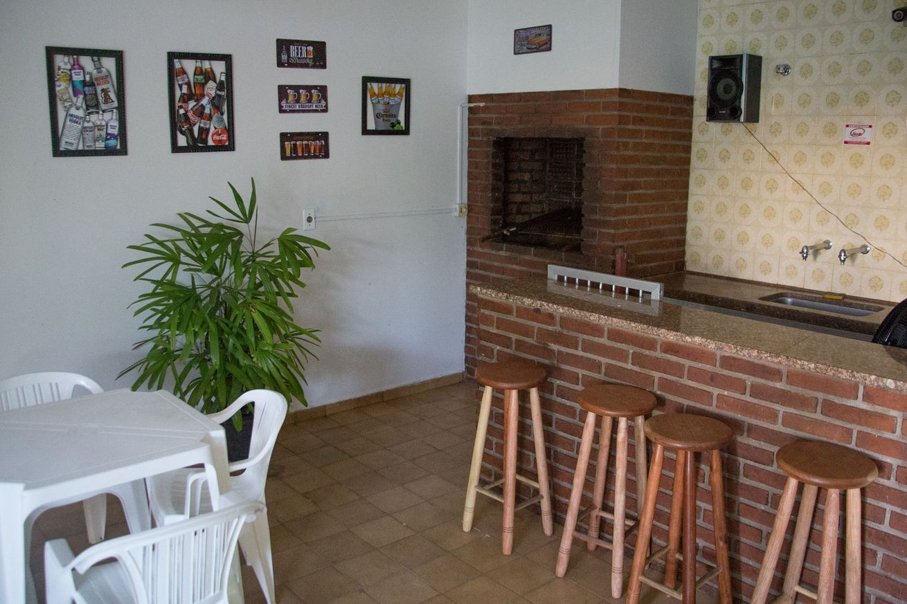 Uma sala com uma mesa e cadeiras e uma parede de tijolos