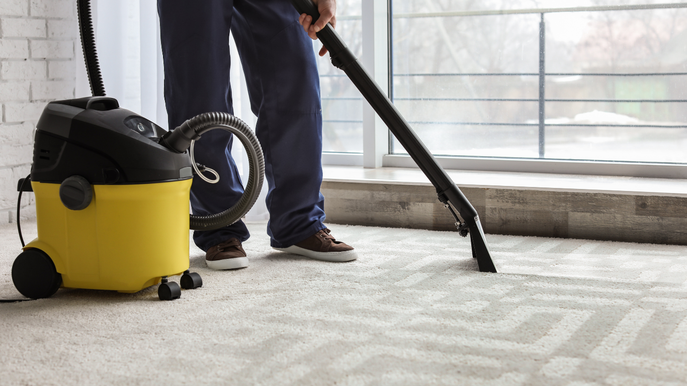 A rug cleaning machine in action, scrubbing a patterned rug with foamy white liquid.