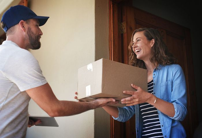 Deliver Man Handing Package — Fort Wayne, IN — Jonny on The Spot