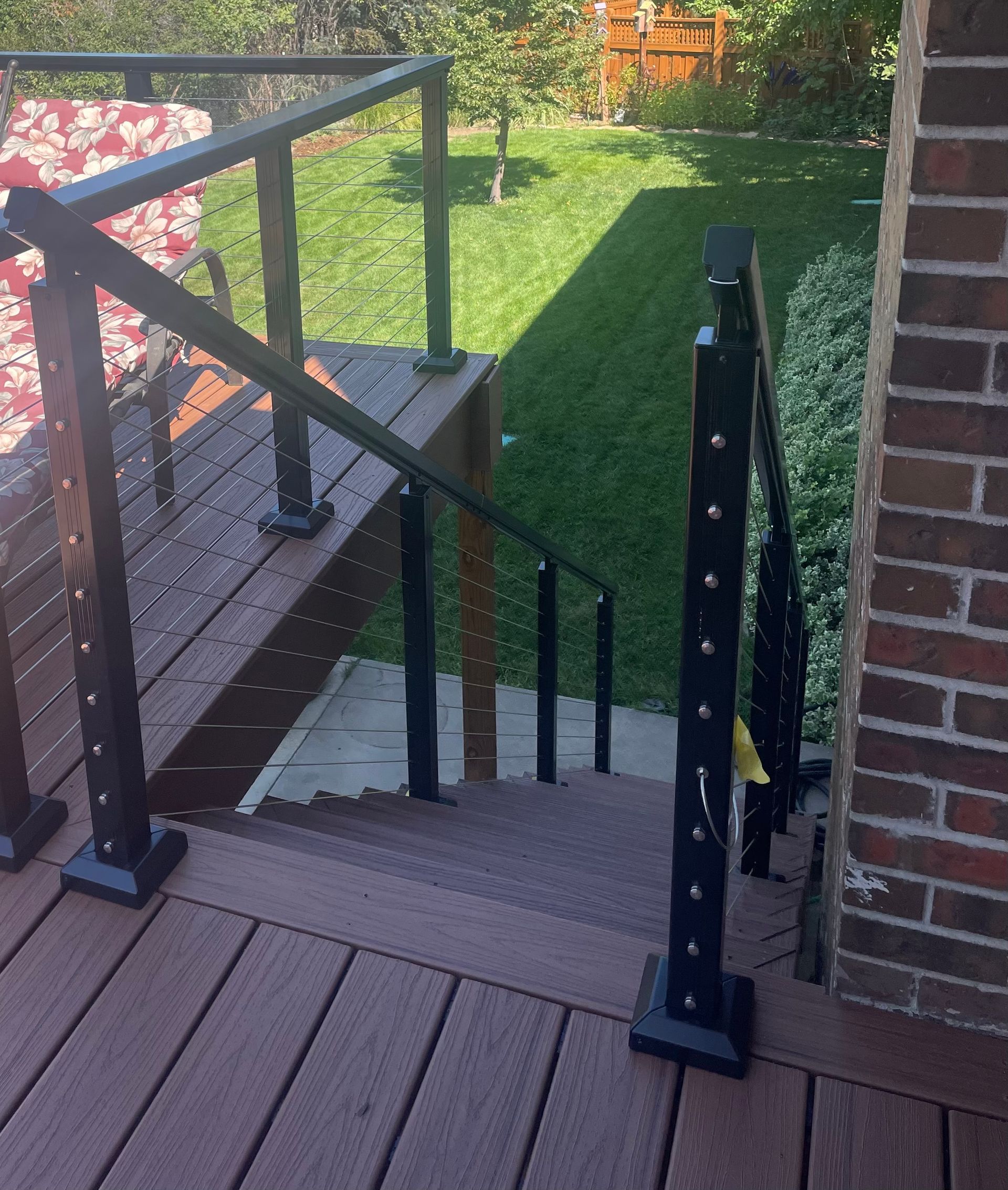 Stairs leading up to a deck with a black railing