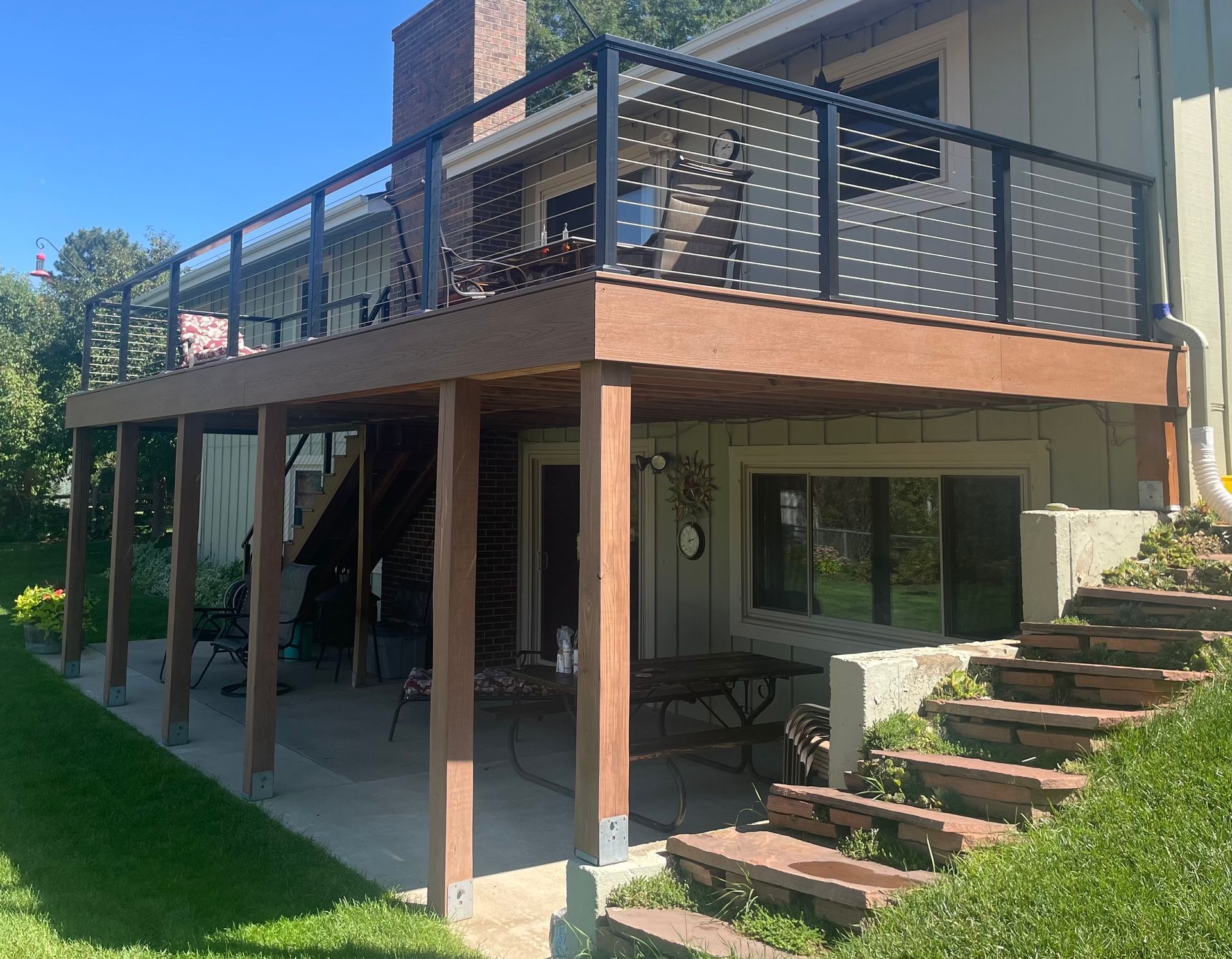 A house with a large deck and stairs leading up to it.