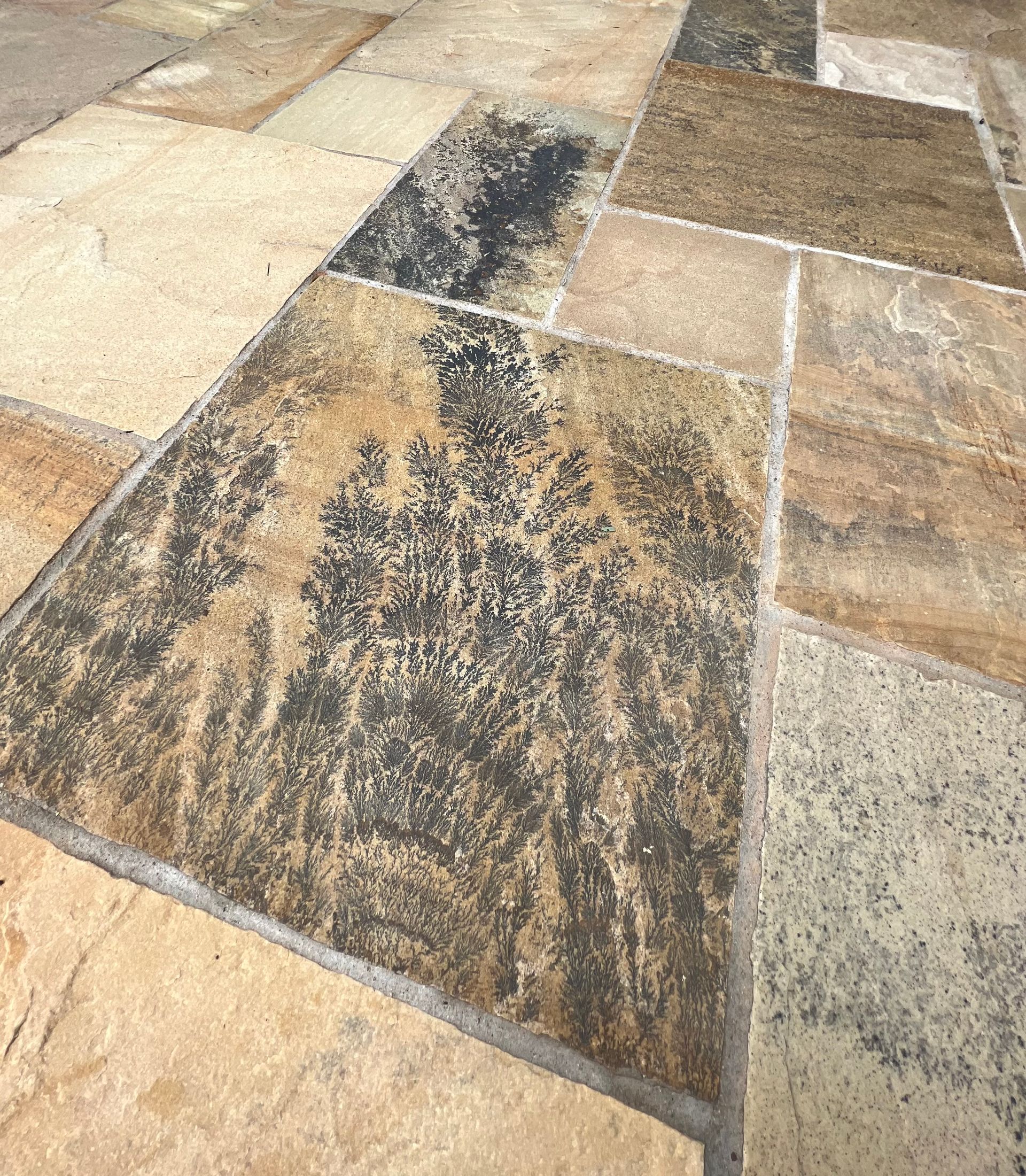 A close up of a tile floor with a marble texture.