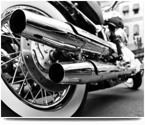 Black and white rear view of a classic motorcycle.