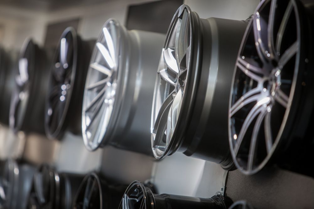 A Row of Wheels Hanging on a Wall in a Store — D & B Rim Repairs In Wingham, NSW