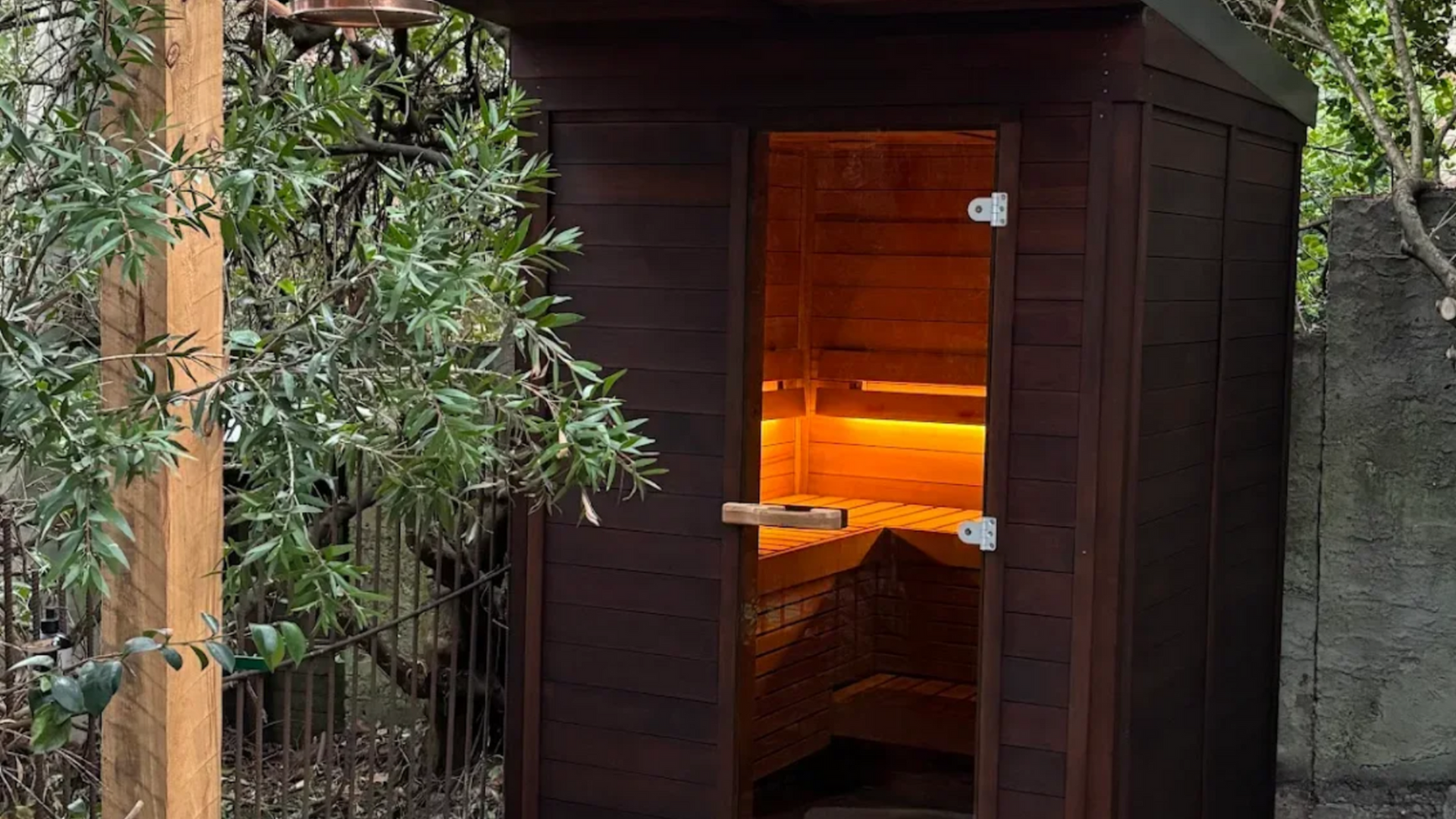 A wooden sauna with a lot of chairs and a table.