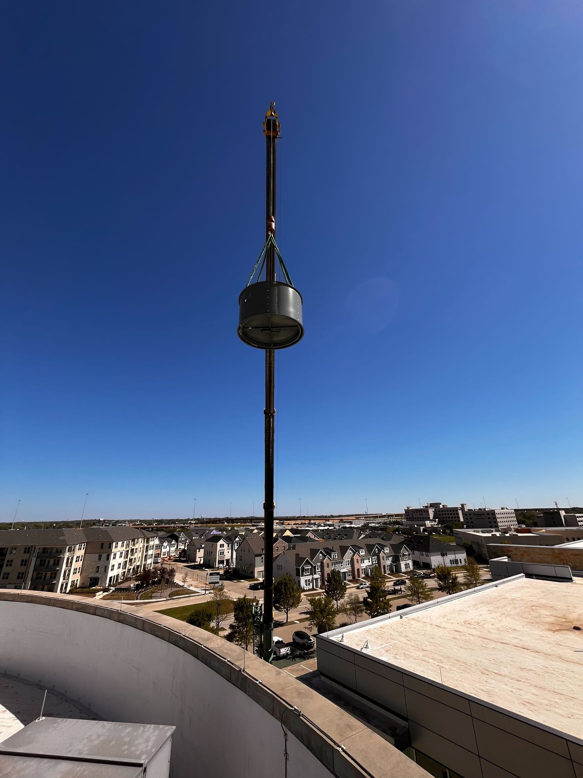 A large tower is sitting on top of a building overlooking a city.