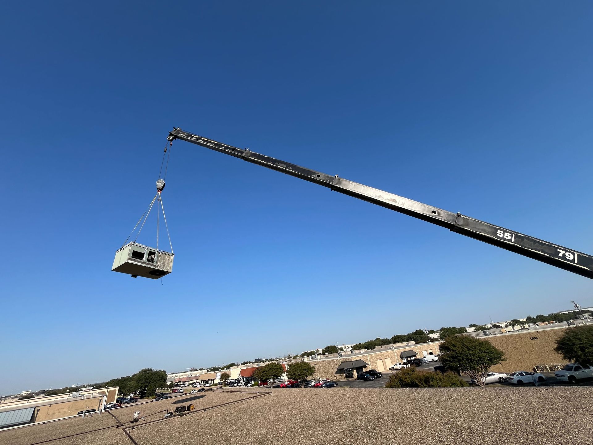 A large crane is lifting a large object in the air
