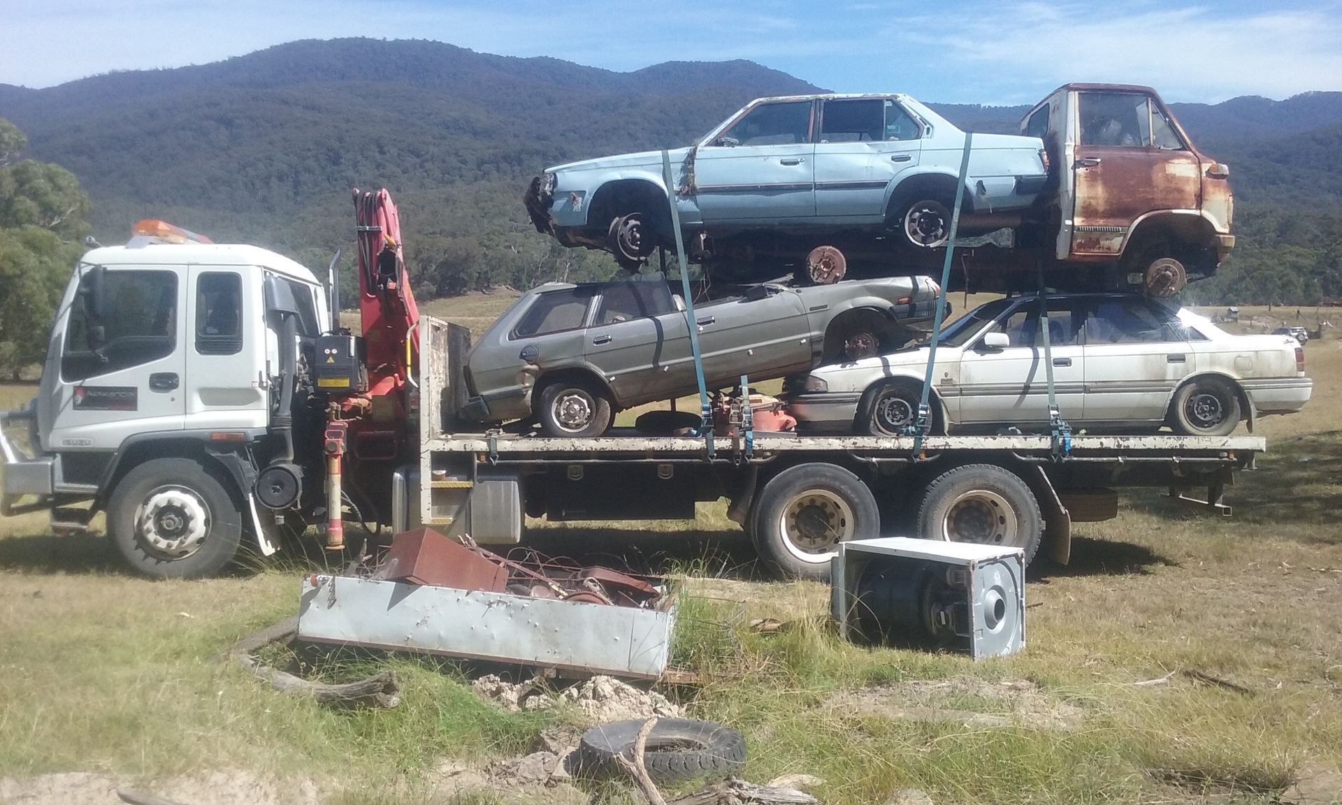 A Tow Truck is Carrying a Stack of Cars on Top of It — Alexander Crane Tippers in Latham, ACT