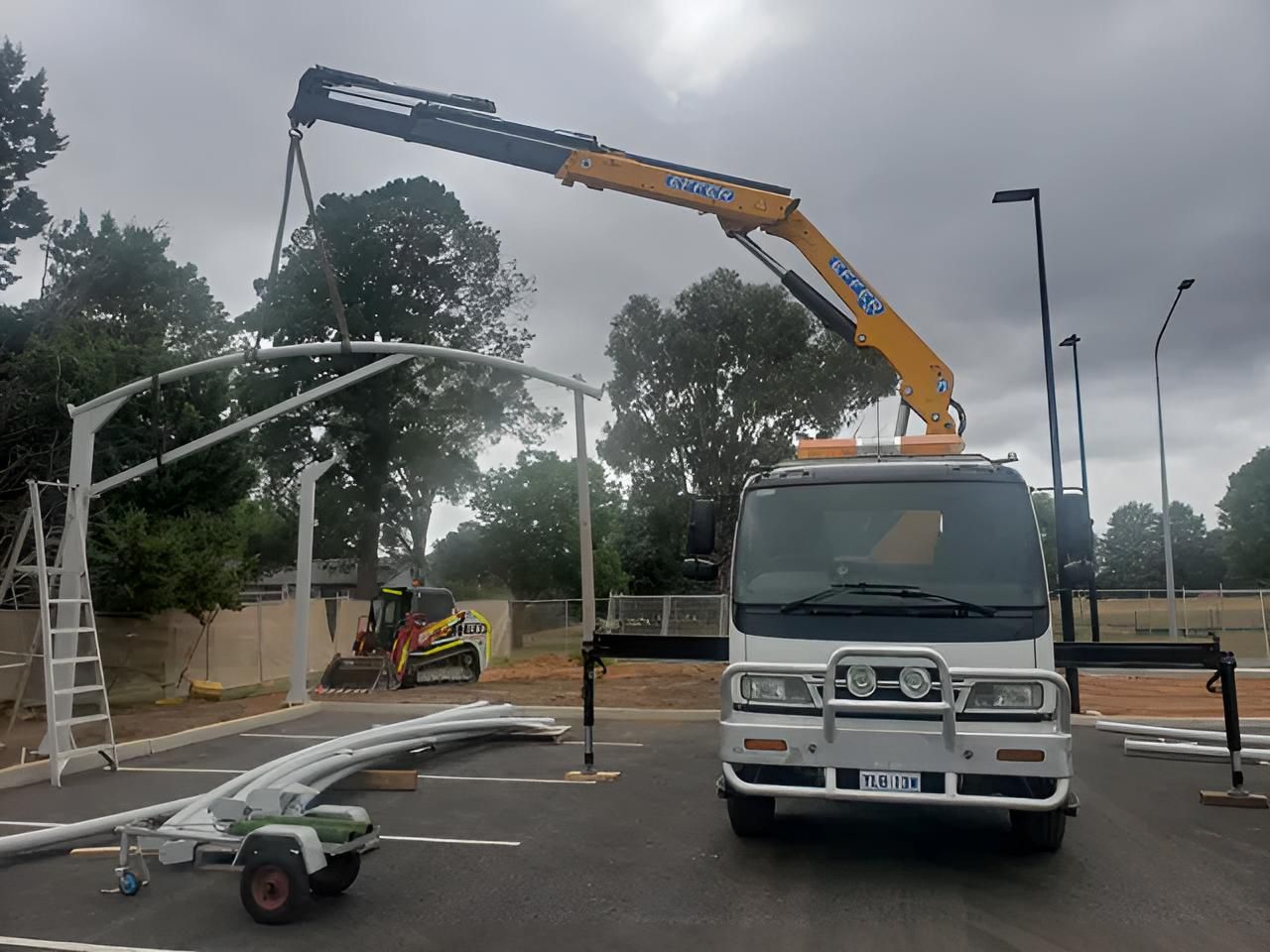 A Truck With a Crane on Top of It is Parked in a Parking Lot — Alexander Crane Tippers in Latham, ACT