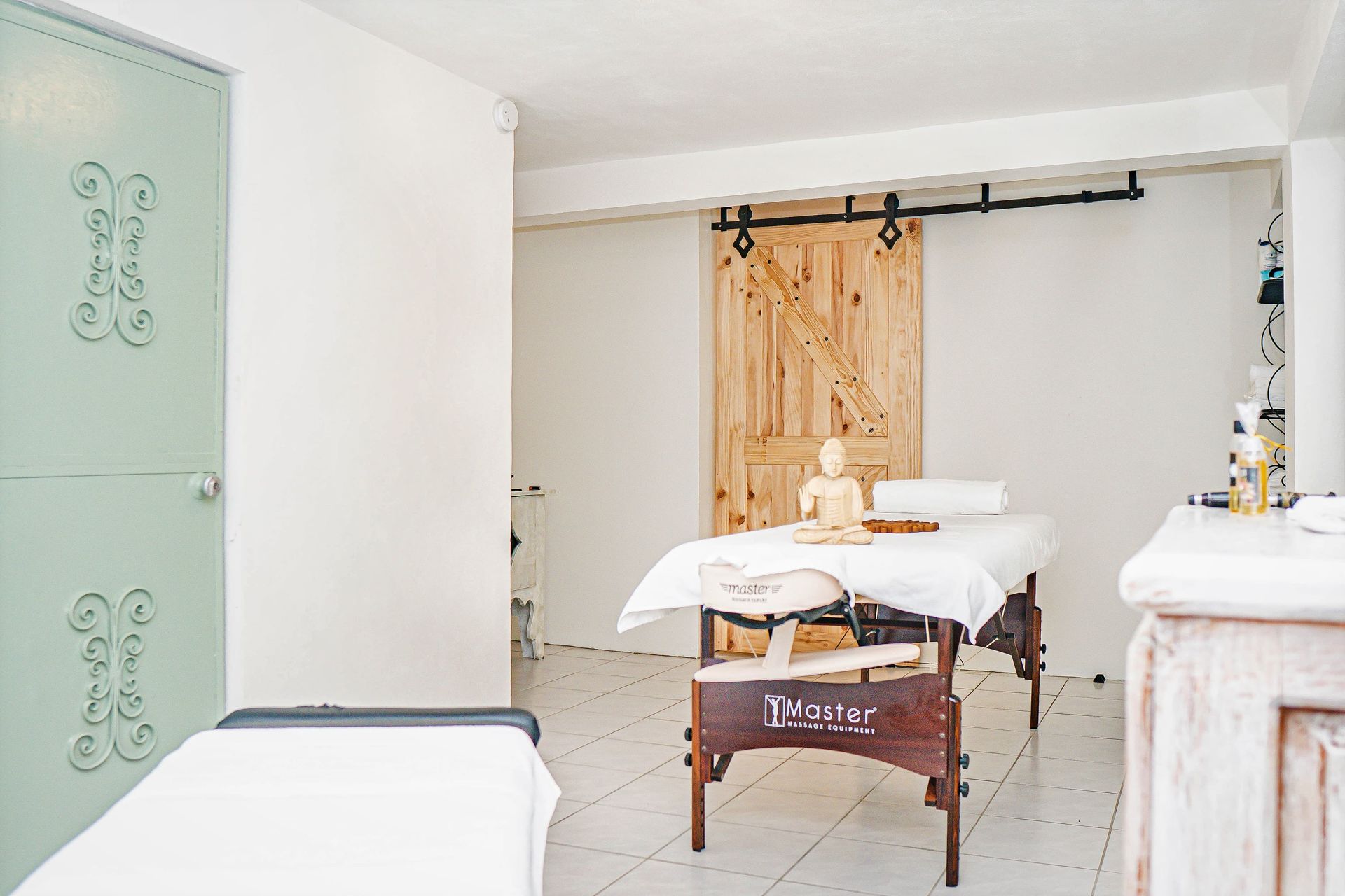 A massage table in a room with a sliding barn door.