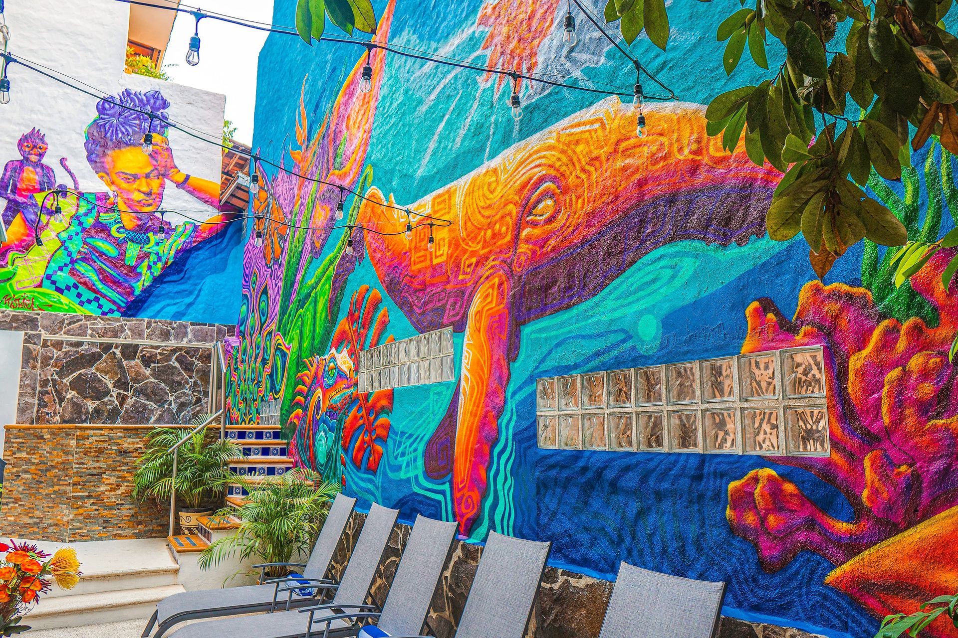 There is a large mural on the side of a building.