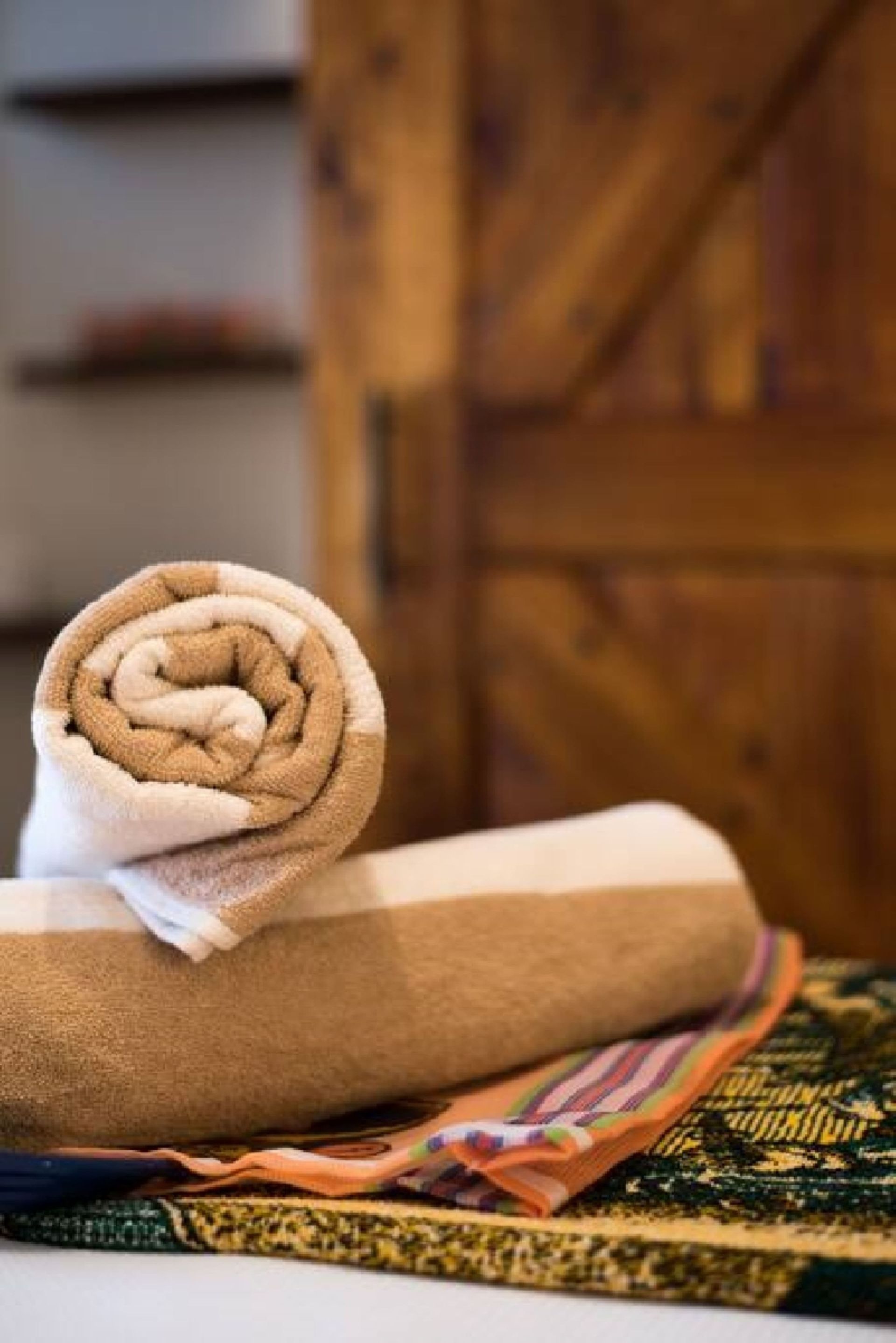 A rolled up towel is sitting on top of a table.