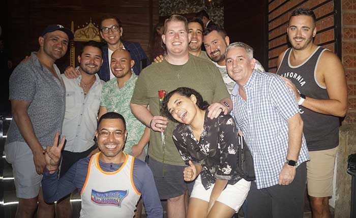 A group of men and women are posing for a picture together.