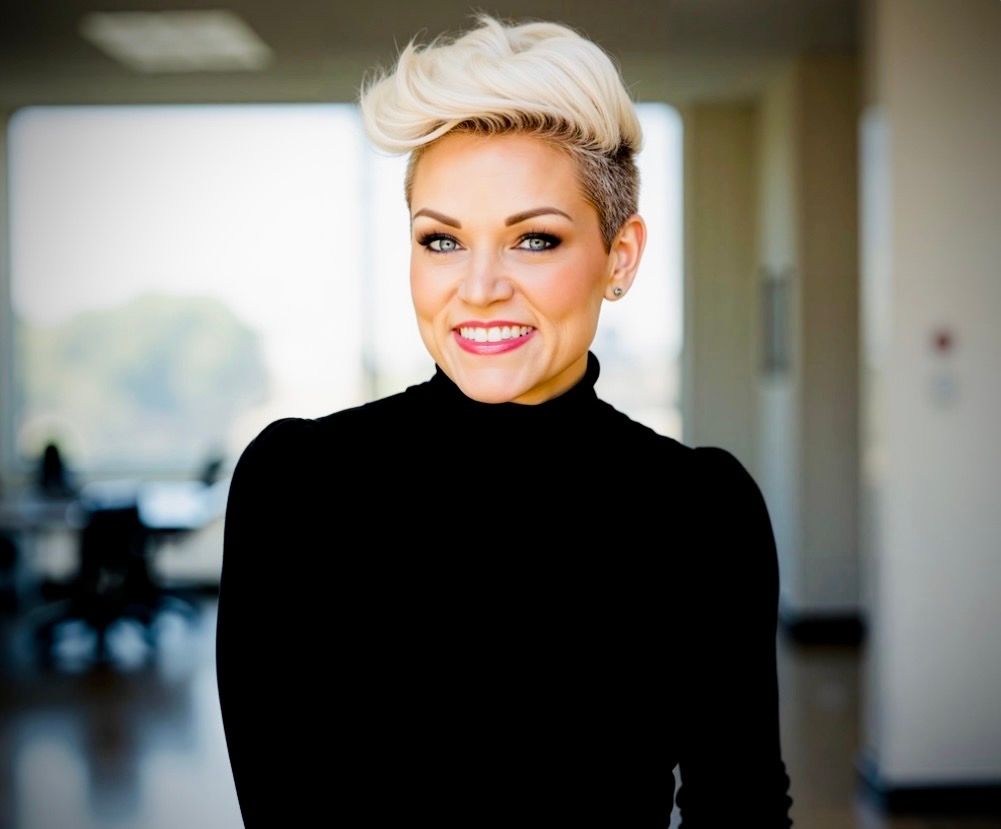 A man in a suit and tie is smiling for the camera