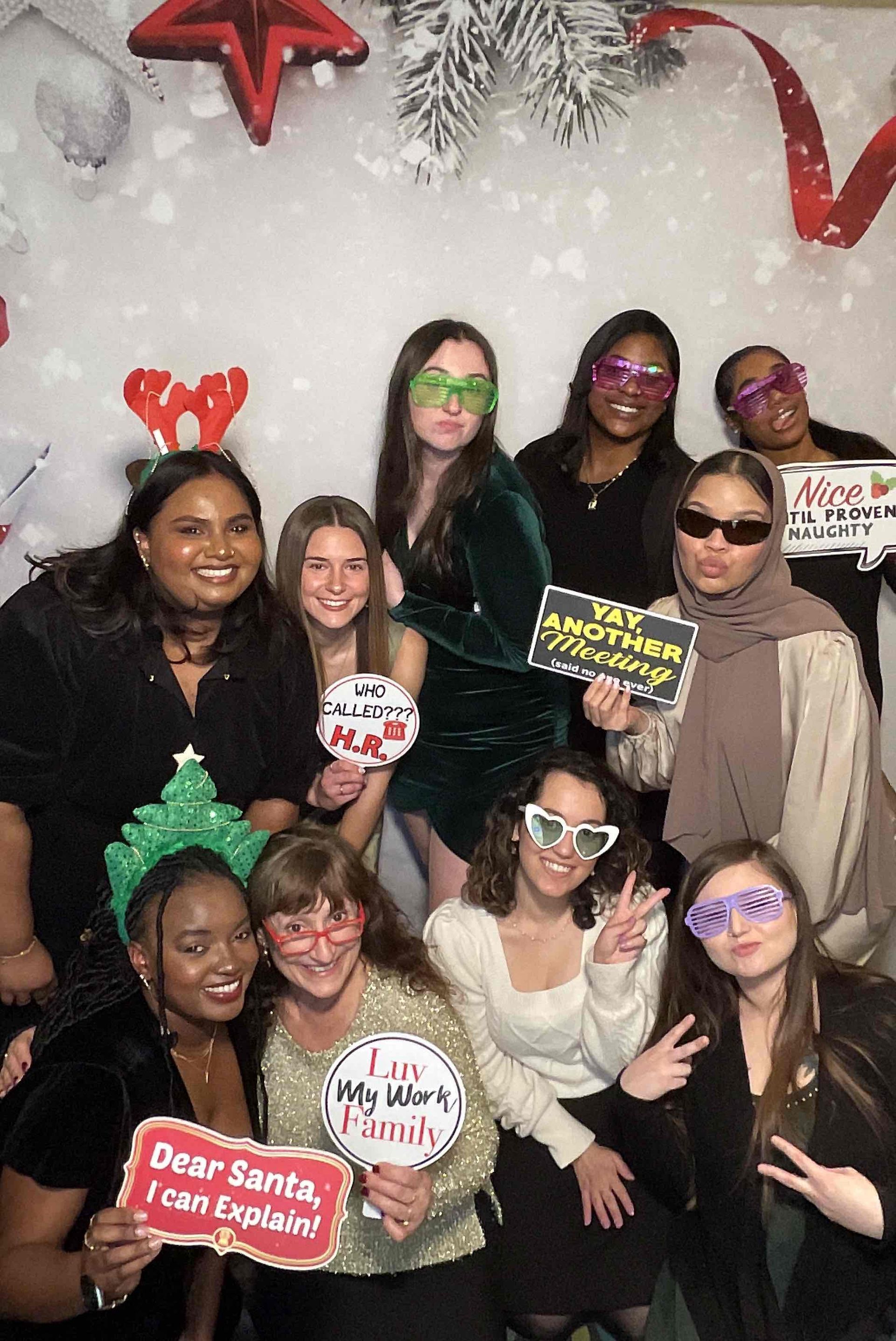 A group of women are posing for a picture in a photo booth.