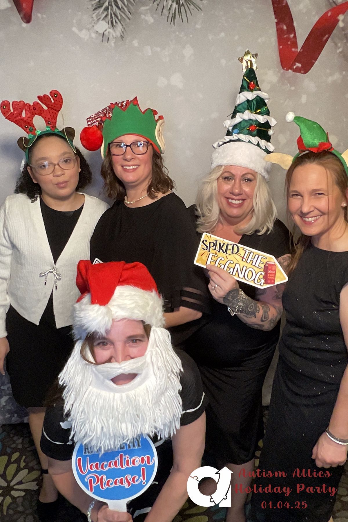 A group of women are posing for a picture in a photo booth.