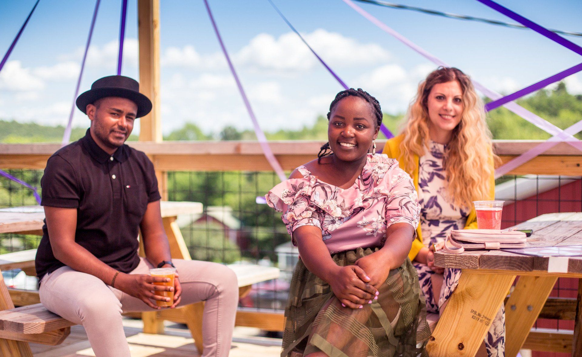 A group of people are sitting at a picnic table.