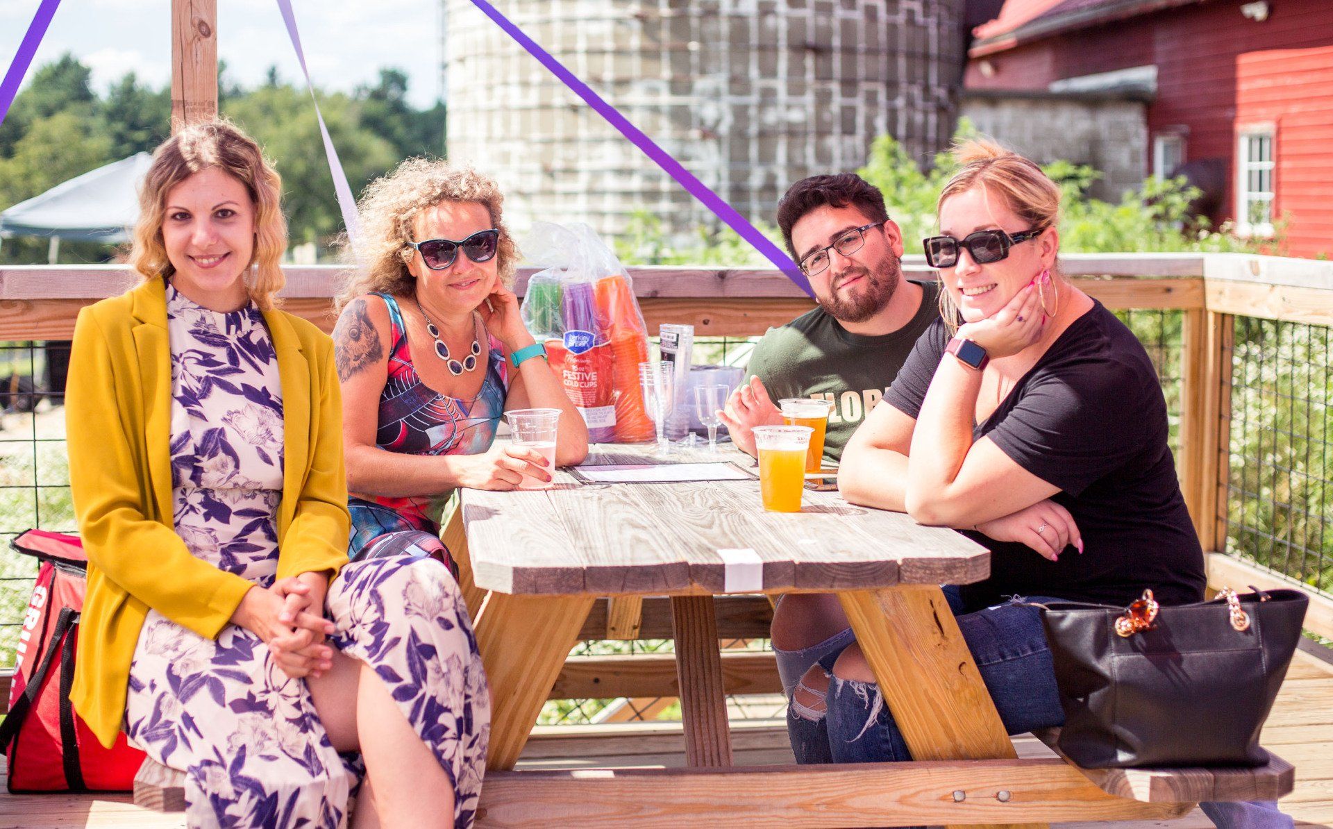 A group of people are sitting at a picnic table.