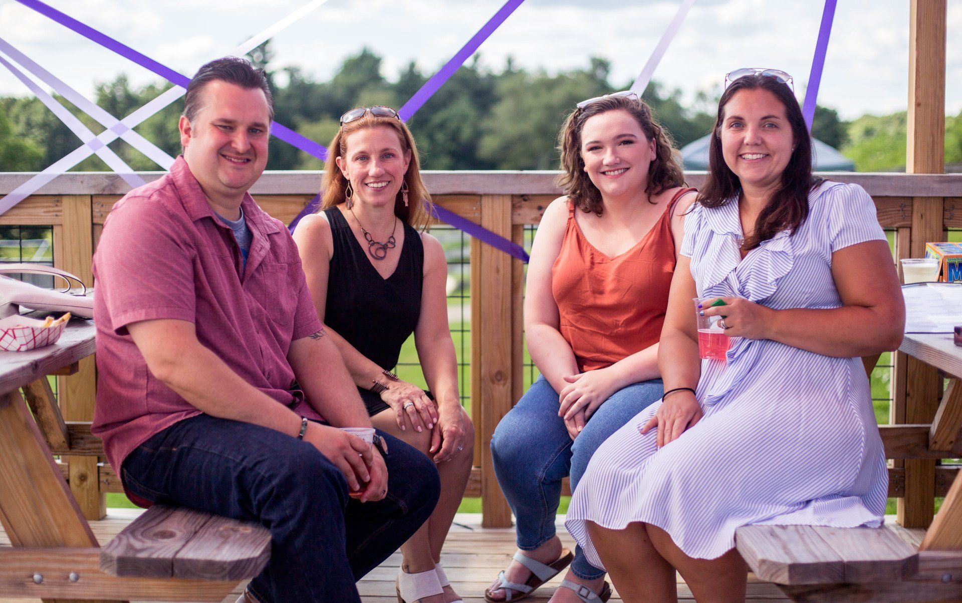 A group of people are sitting at a picnic table.