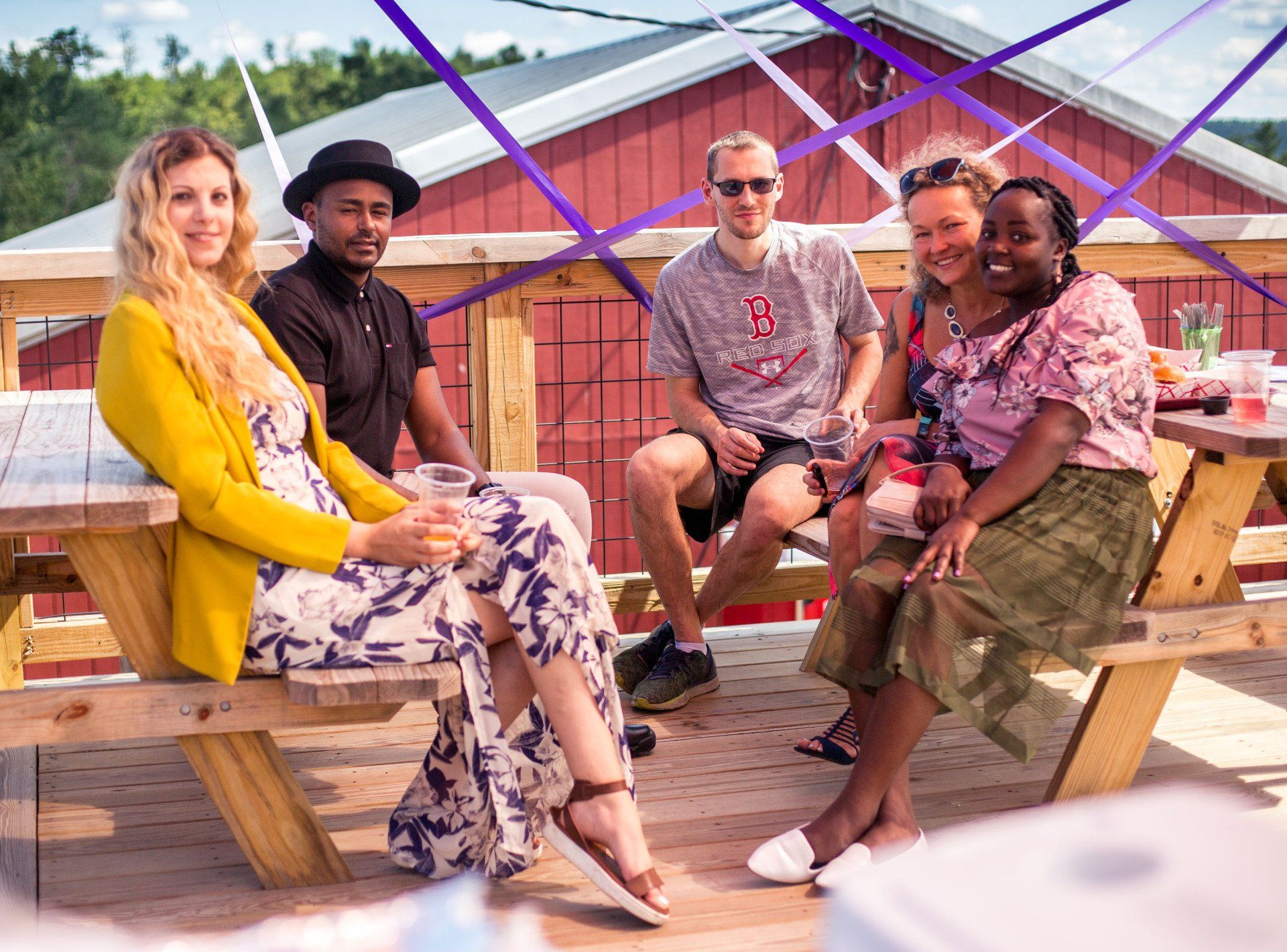 A group of people are sitting at a picnic table.