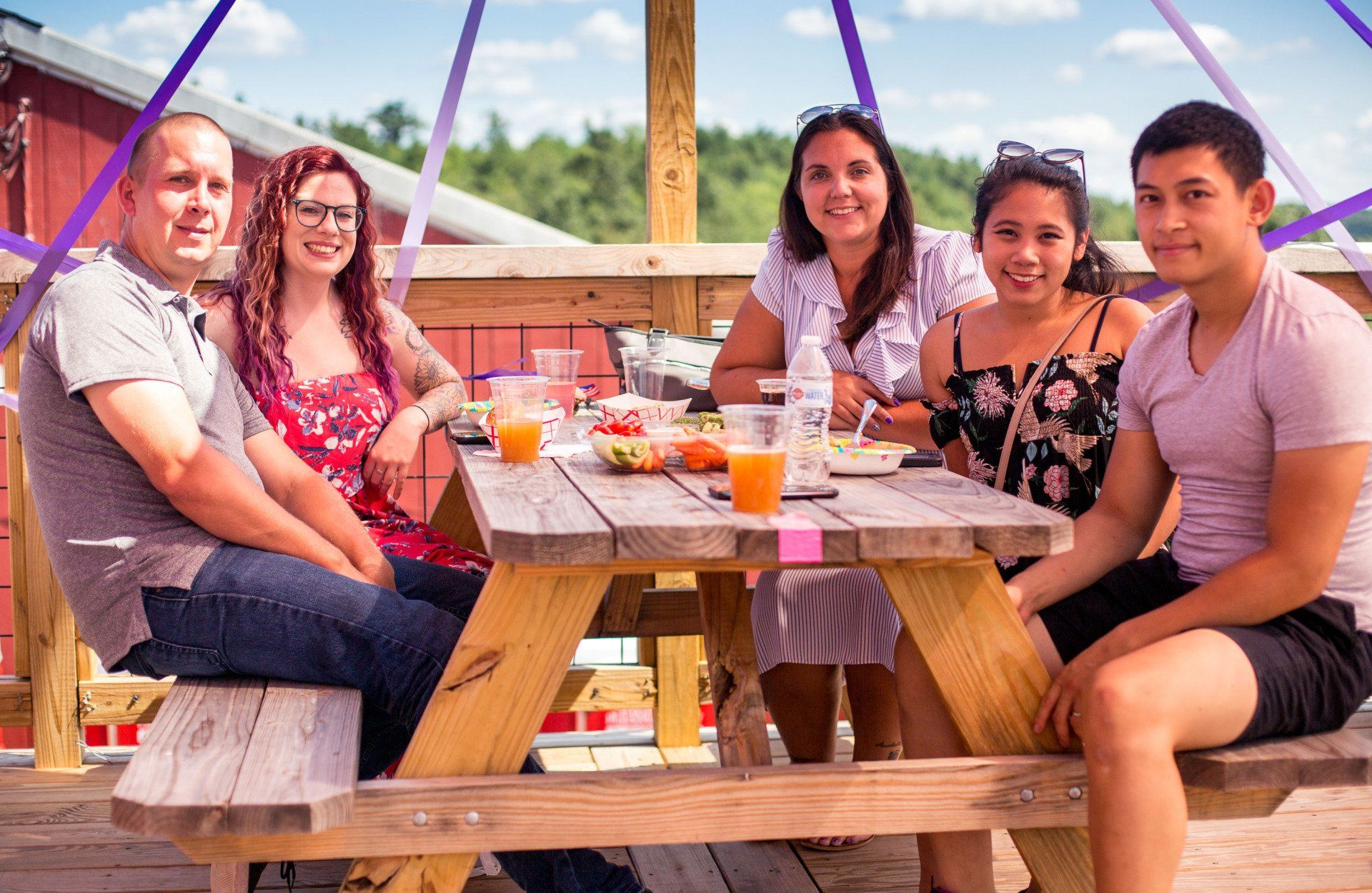 A group of people are sitting at a picnic table.