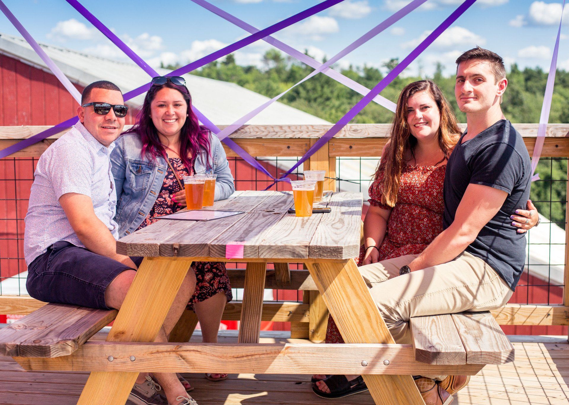 A group of people are sitting at a picnic table.