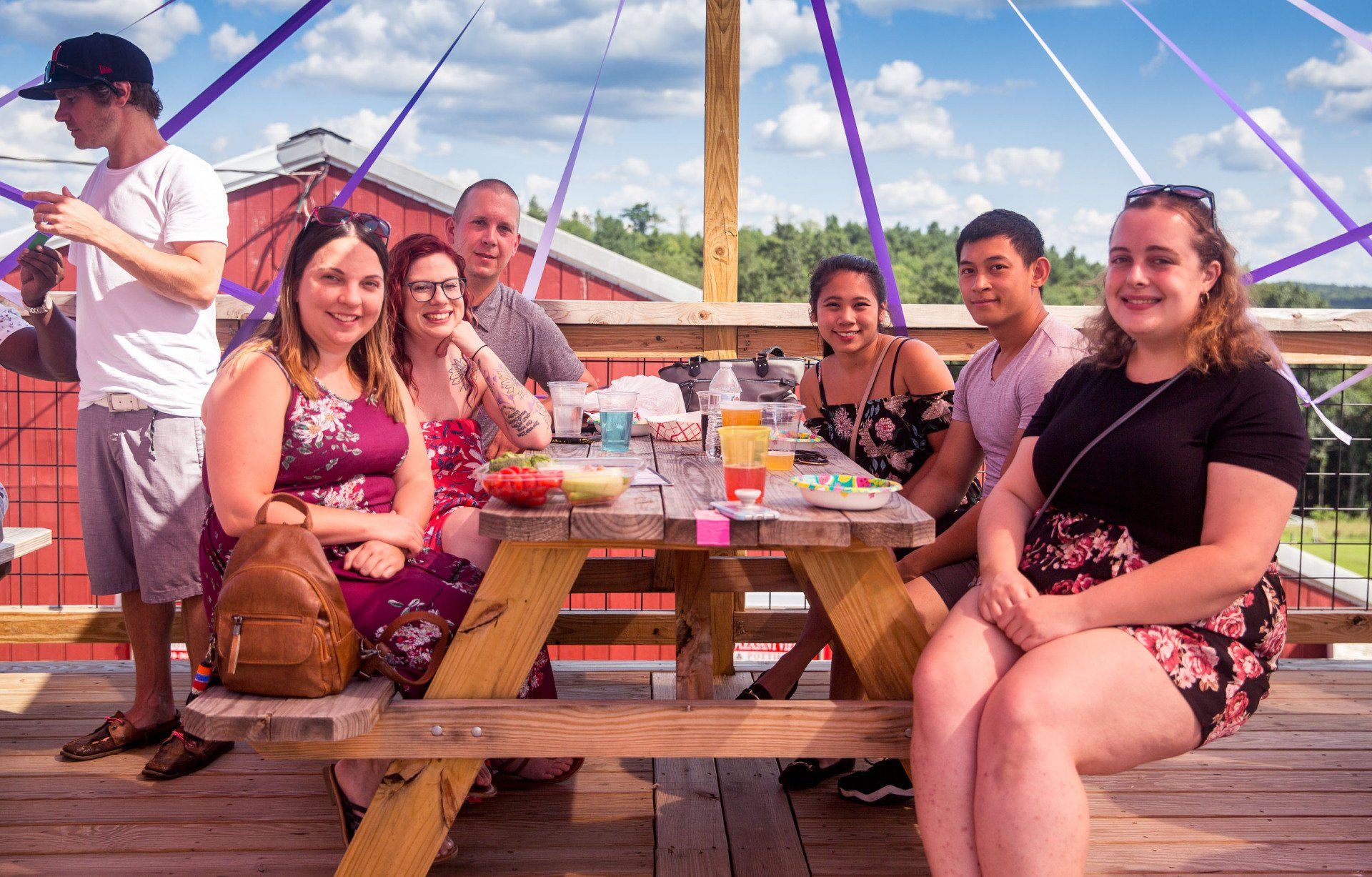 A group of people are sitting at a picnic table.