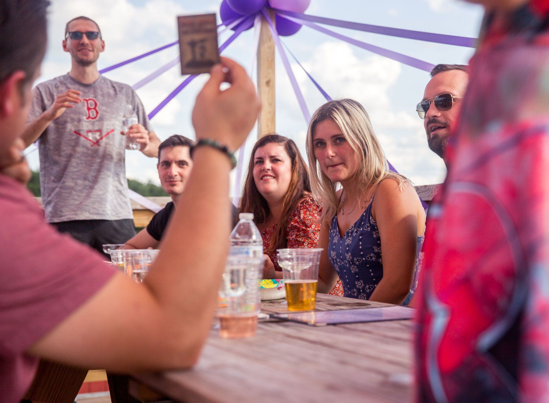 A man is taking a picture of a group of people sitting at a table.