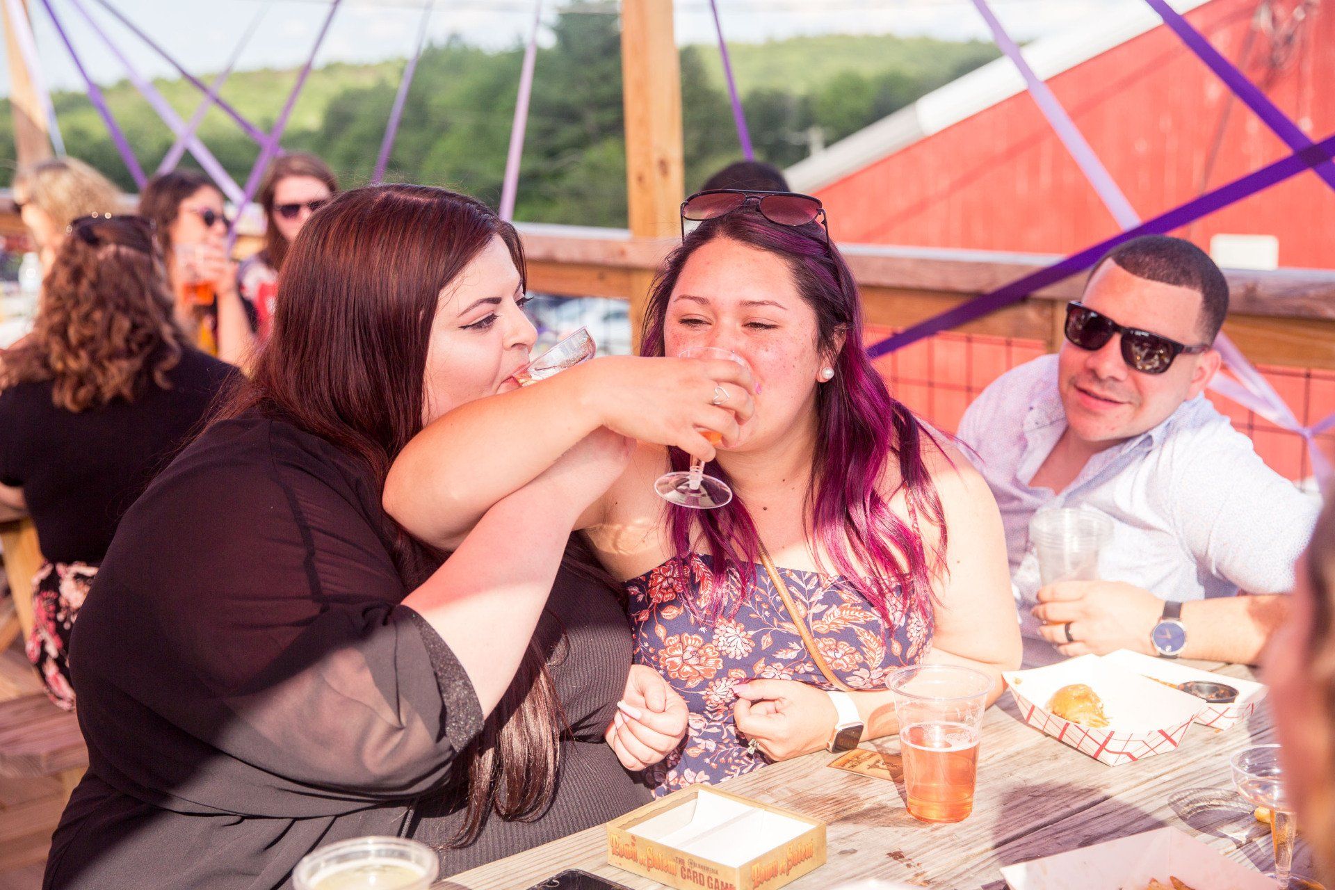 A group of people are sitting at a table drinking wine.