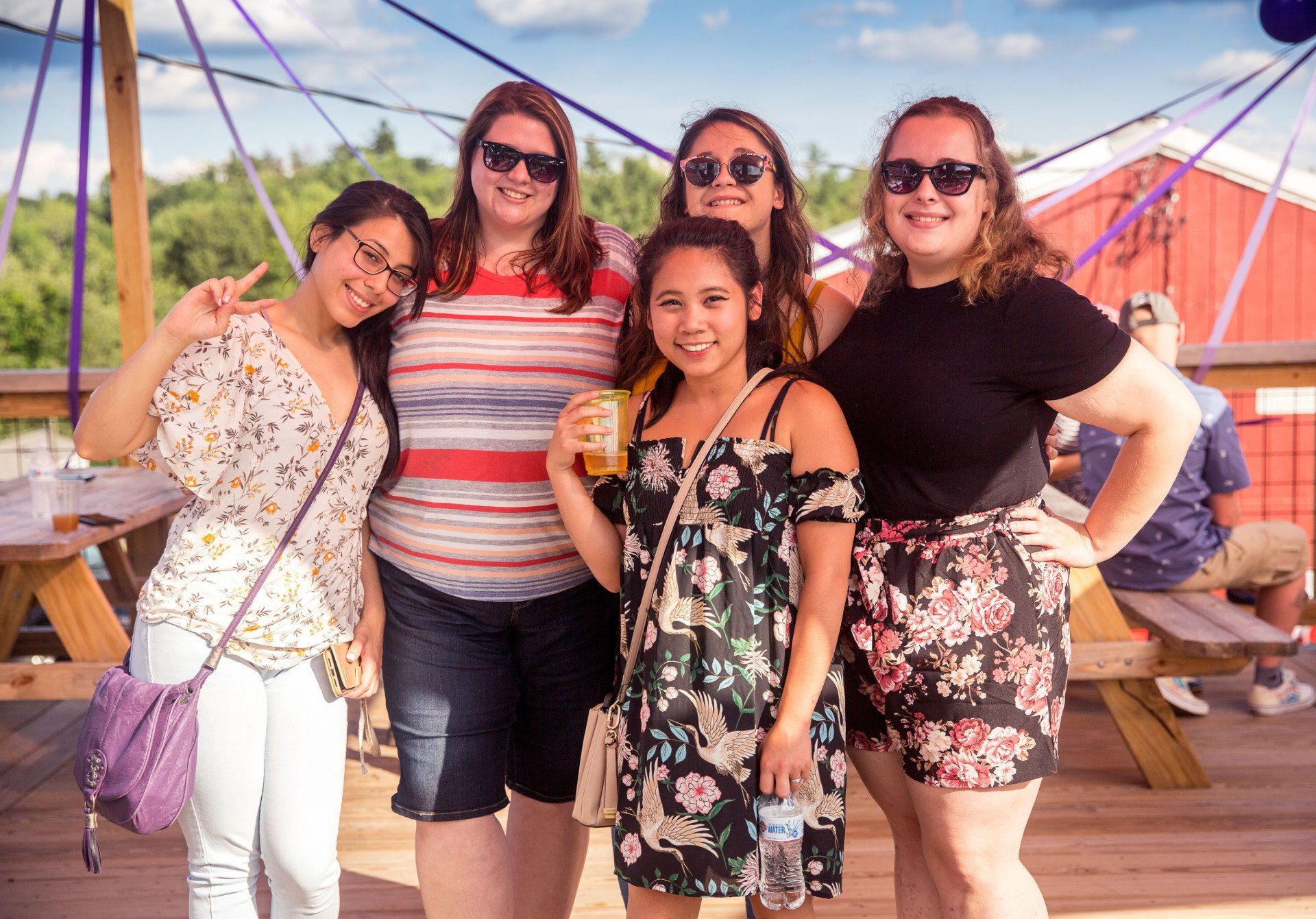 A group of women are posing for a picture on a deck.