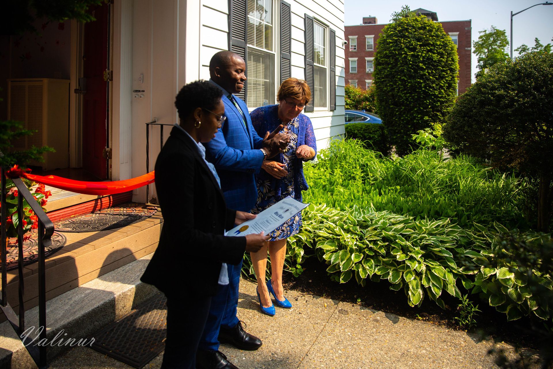 A group of people are standing outside of a building