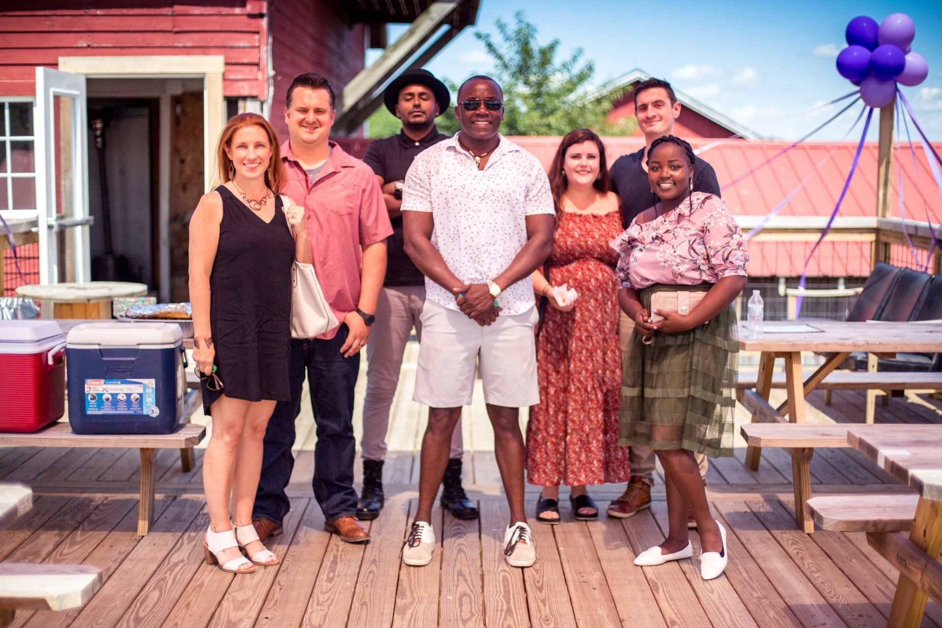 A group of people are posing for a picture on a deck.