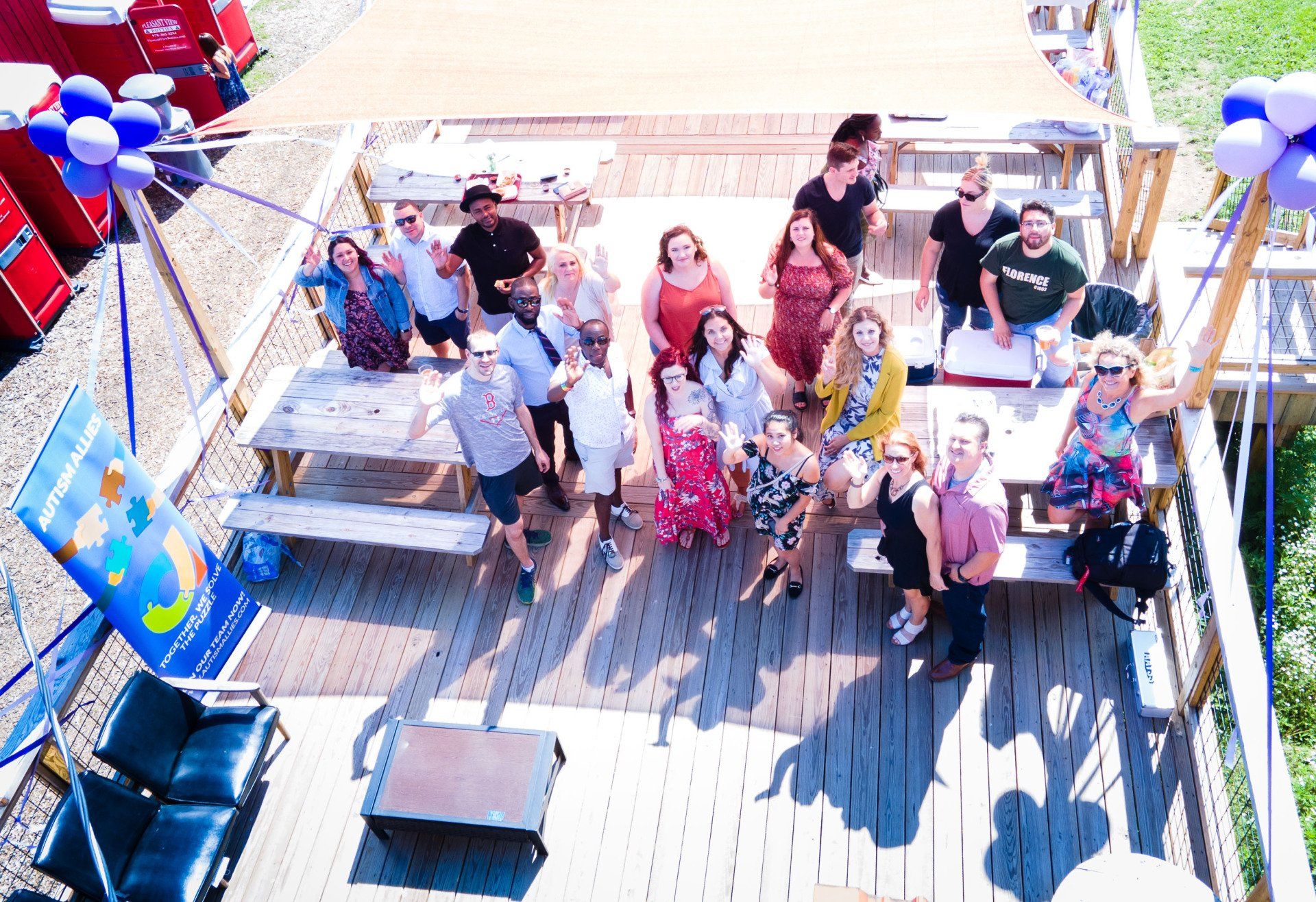 A group of people are posing for a picture on a deck.