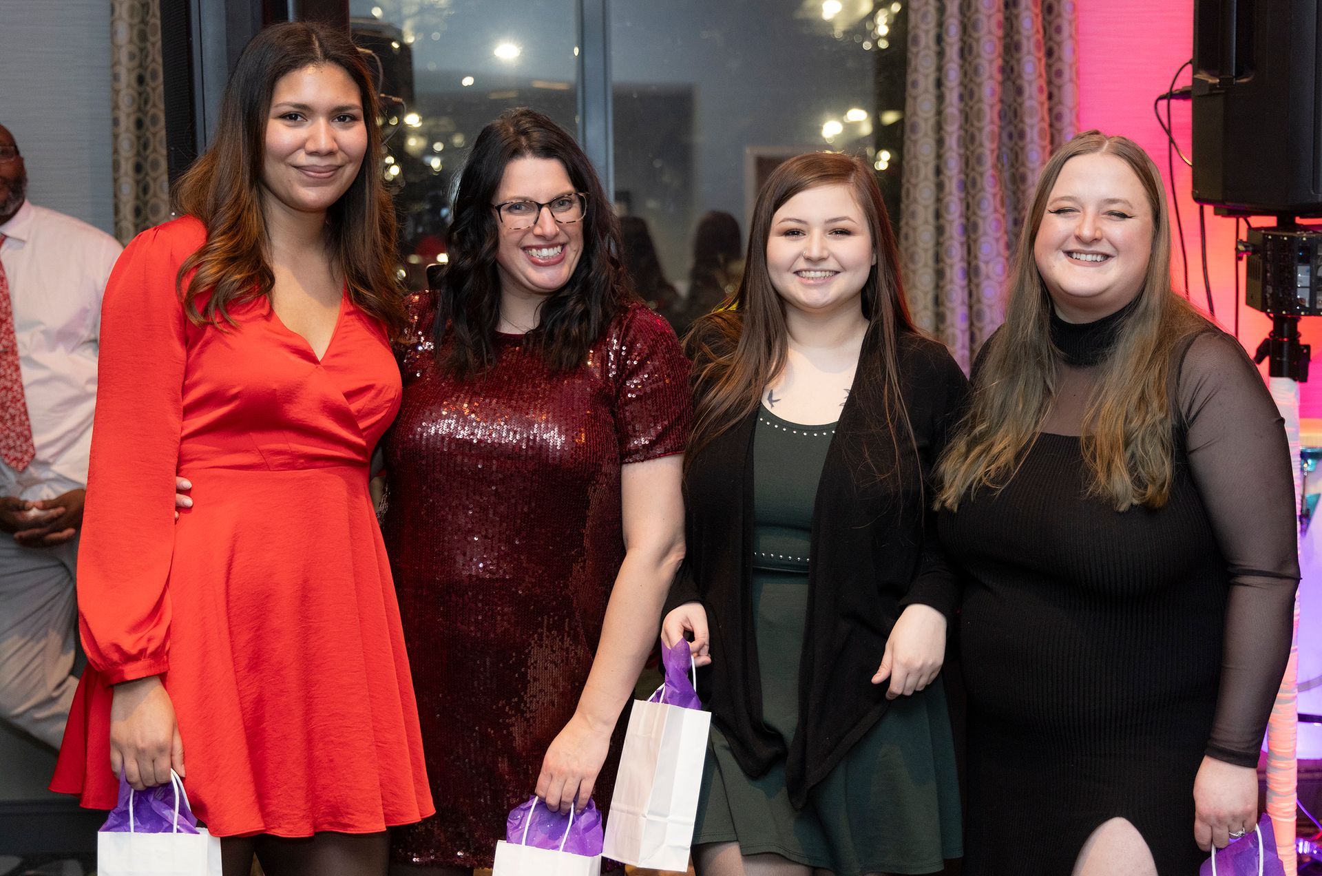 A group of women are posing for a picture at a party.