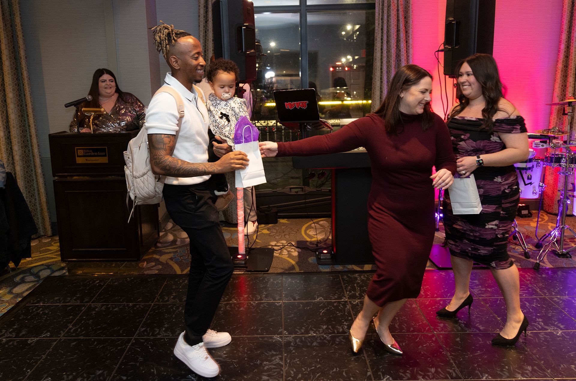 A group of people are dancing on a dance floor at a party.