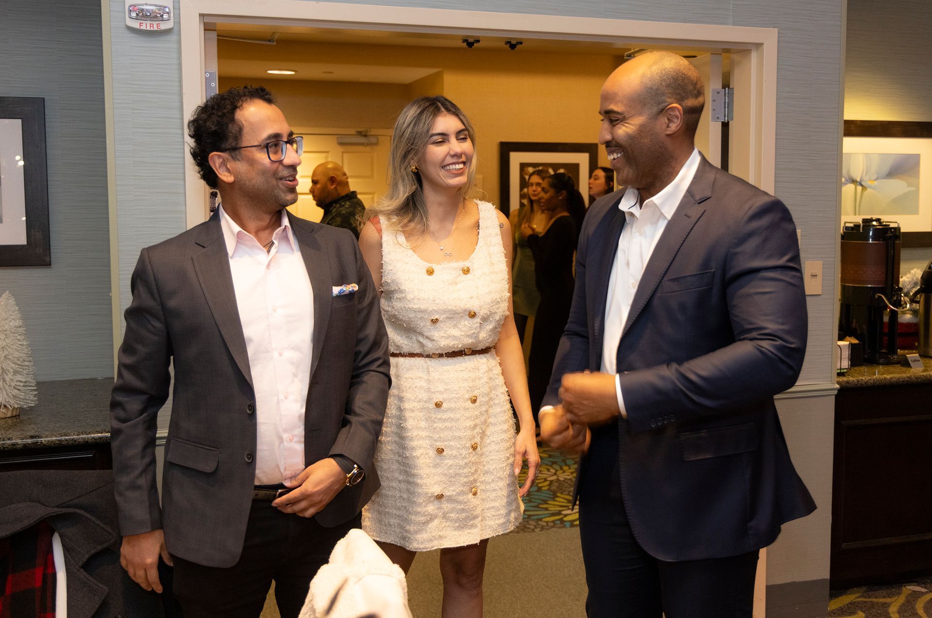 A group of people are standing next to each other in a room.