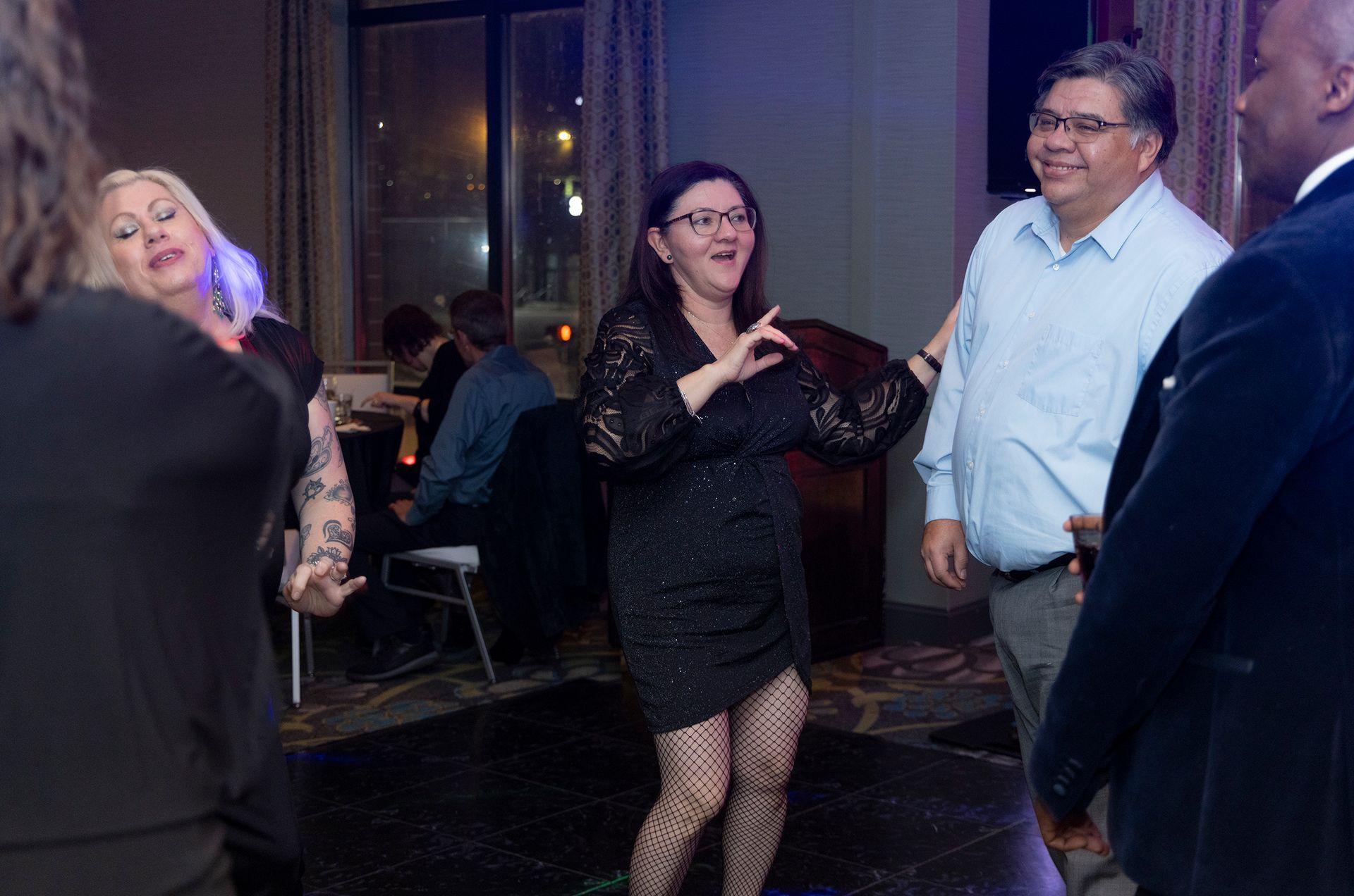 A group of people are dancing on a dance floor at a party.