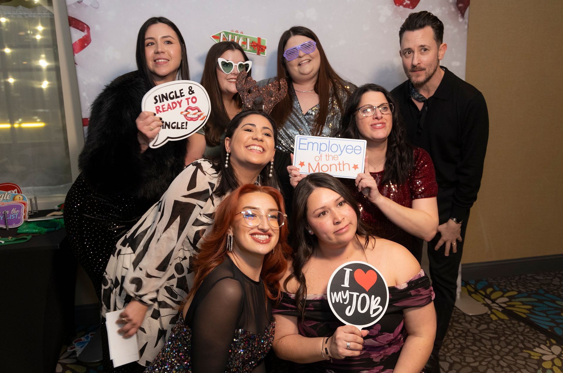 A group of people are posing for a picture in a photo booth.
