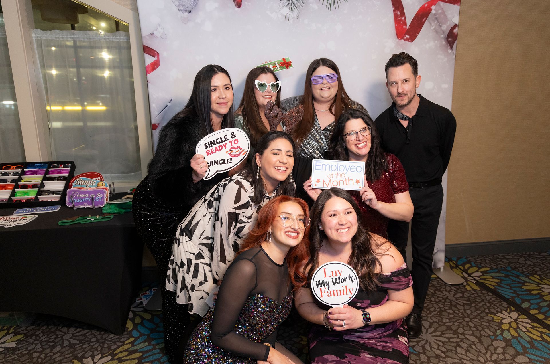 A group of people are posing for a picture in front of a photo booth.
