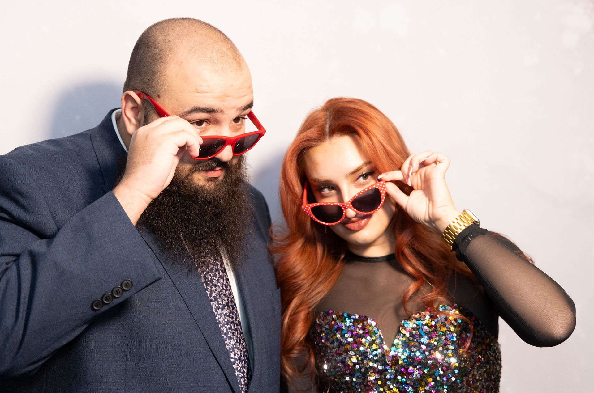 A man with a beard and a woman with red hair are posing for a picture.