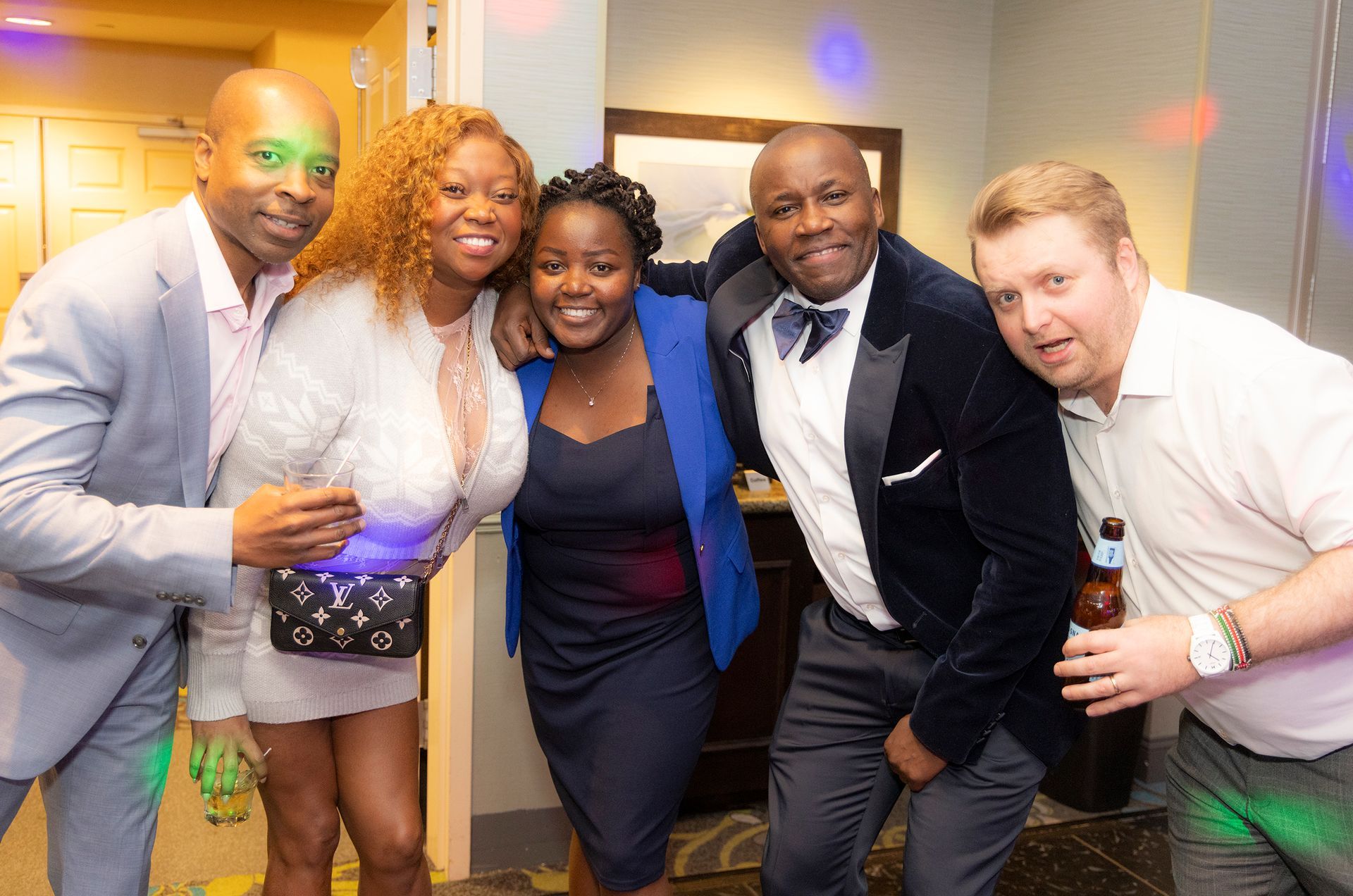 A group of people are posing for a picture at a party.
