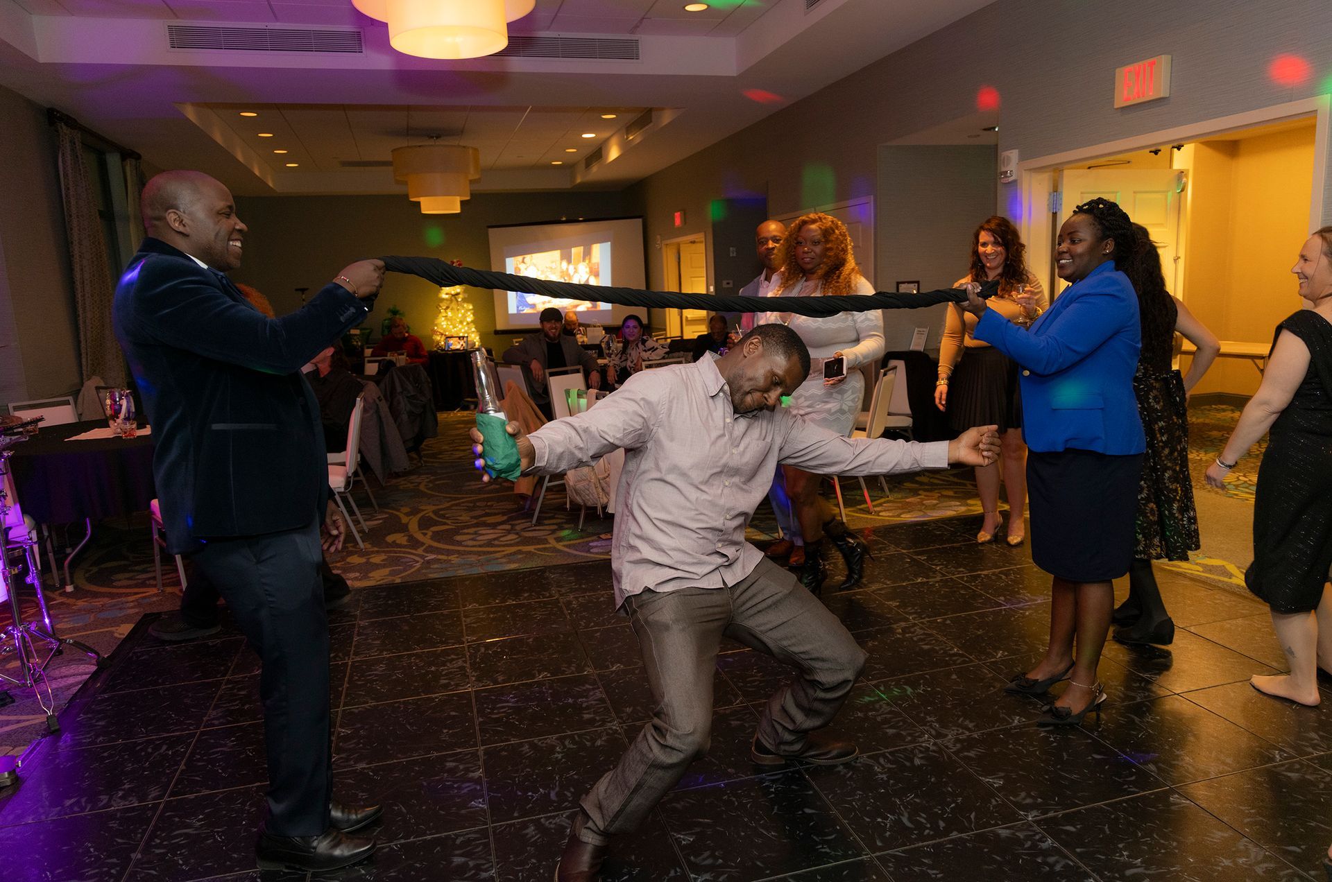 A group of people are dancing on a dance floor at a party.