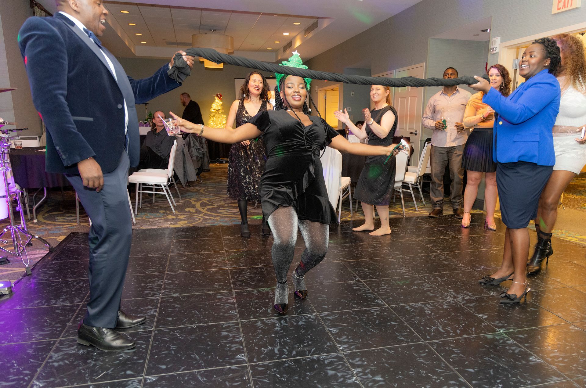 A group of people are dancing on a dance floor at a party.
