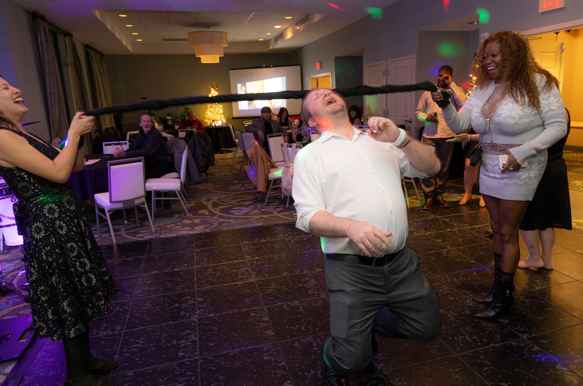 A group of people are dancing in a room at a party.