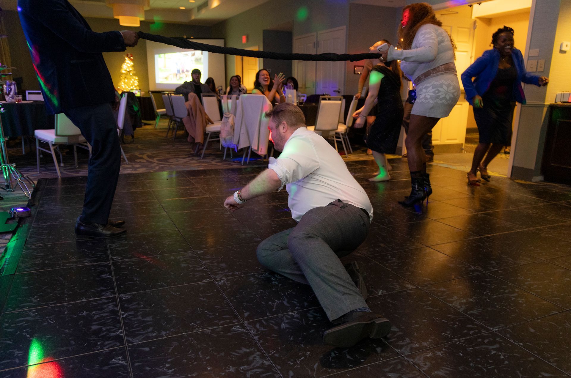 A group of people are dancing on a dance floor at a party.