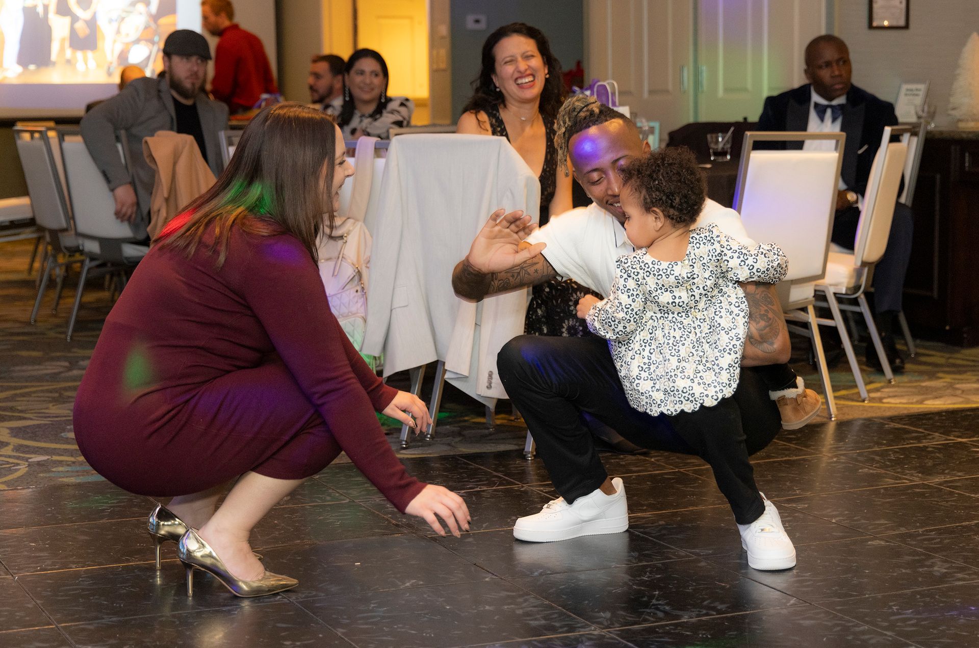 A group of people are dancing on a dance floor at a party.