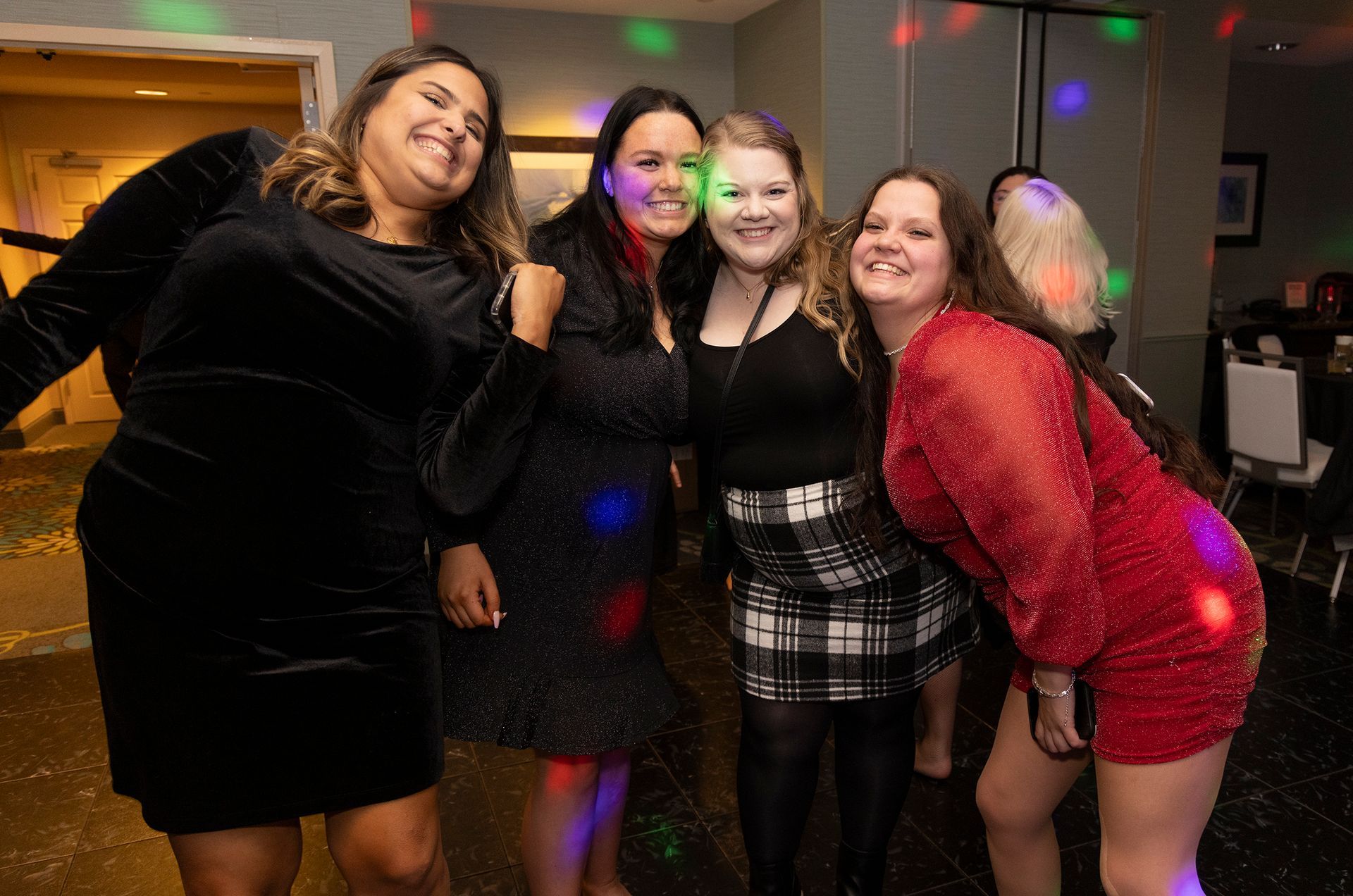 A group of women are posing for a picture at a party.