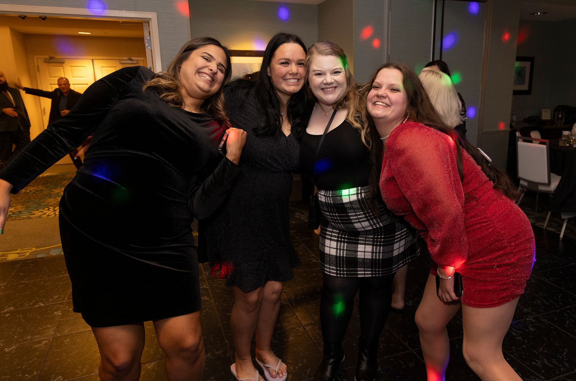 A group of women are posing for a picture at a party.