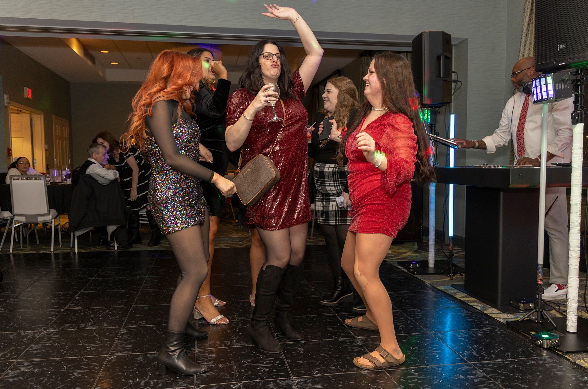 A group of women are dancing on a dance floor at a party.